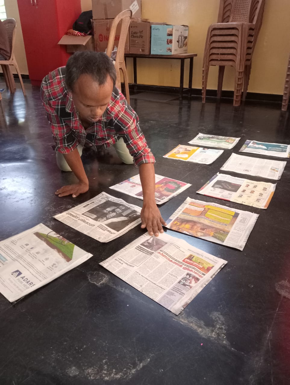 Older child sorting newspapers